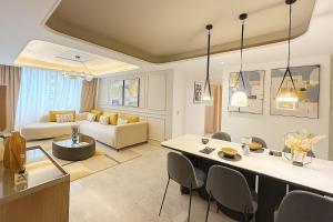 a kitchen and living room with a table and chairs at Modern Elegance Luxury Living City Center in Tangier