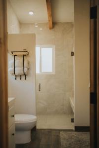 a bathroom with a shower with a toilet and a sink at La Mata de Nuez in Valle de Guadalupe +44 photos