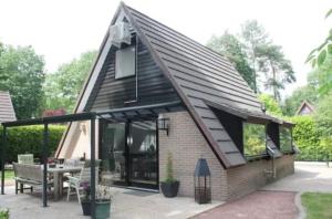 a small house with a pitched roof at Boshuisje Rekem Charly in Lanaken