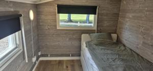 Ένα ή περισσότερα κρεβάτια σε δωμάτιο στο vänerstugan