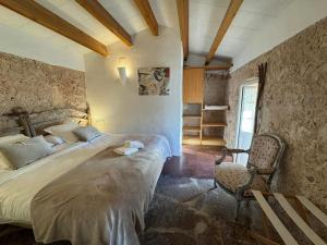 a bedroom with a large bed and a chair at Menorca Agroturismo Llimpet in Alaior +150 photos