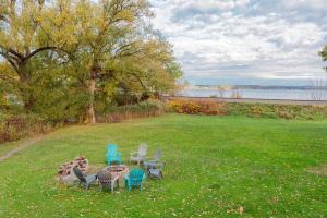 a group of chairs and a table in the grass at Lake Orchard View- 8 BR with Lake Access and Fire Pit in Teall Beach