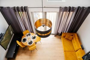 an overhead view of a living room with a table and chairs at Domek w Lelewie in Lelewo +13 photos