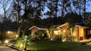 a house with lights in the yard at night at Villa Titoune, le charme du Coeur de Bassin, à 2 familles ou entre amis in Lanton +21 photos