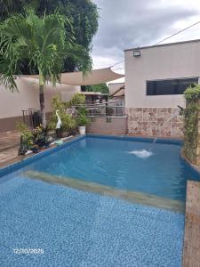 a swimming pool in front of a house at Recanto Morada Amazônica in Manaus +2 photos