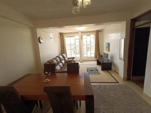 a living room with a table and a couch at The Cliff in Nairobi