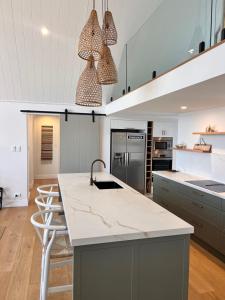 a kitchen with a large island with a counter top at Capri House in Clareville