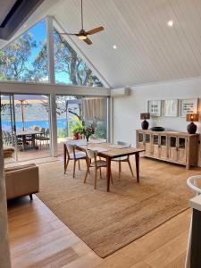a kitchen and dining room with a table and chairs at Capri House in Clareville