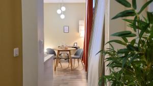 a hallway with a table and chairs in a room at L'Eden Rouennais - Gare de Rouen in Rouen