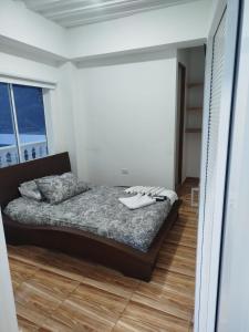 a bedroom with a bed with shoes on it at hotel salome in Puerto Triunfo