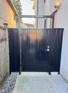 a black gate in front of a building at Excellent Place to Stay in Coquitlam +2 photos