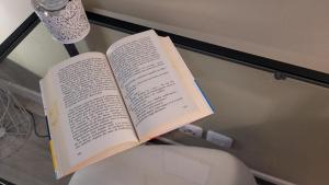 an open book sitting on top of a glass table at L'Eden Rouennais - Gare de Rouen in Rouen