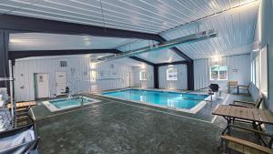 a large swimming pool in a building with at Riverfront Motel & Cabins in Thompson Falls