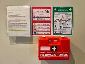 a sign on a wall with a red box at KWADRAT hostel in Roztworowo +28 photos