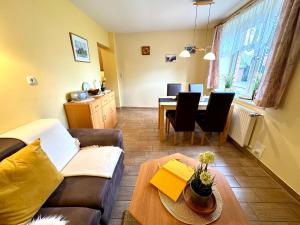 a living room with a couch and a table at BAUERNHAUS KRULL App 03 in Althagen