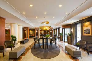 a lobby with a table and chairs in a building at Starhotels Tourist in Milan