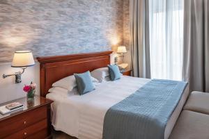 Giường trong phòng chung tại Starhotels Terminus