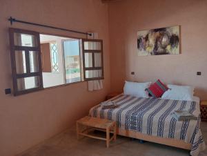 a bedroom with a bed and a window at LA HACIENDA Agafay Desert  +37 photos