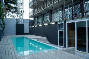 a swimming pool in front of a building at Dolce Apartment in Buenos Aires