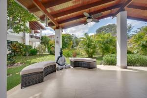 a patio with two benches and a ceiling fan at Villaggio 6 Parque al Lago, Playa Potrero in Potrero