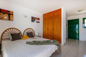 a bedroom with a bed and a wooden door at Caleta Paraiso Sea View 137 in Costa de Antigua +49 photos