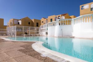 a swimming pool at a resort with buildings at Caleta Paraiso Sea View 137 in Costa de Antigua