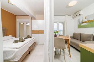 a bedroom with two beds and a table and a couch at Apartments San in Dramalj +72 photos