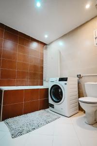 a washing machine in a bathroom with a toilet at L'Andalou -3 bedrooms with Parking in Downtown in Kenitra
