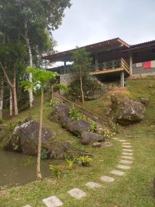 a house on top of a hill with a walkway at Sitio Daniela in São João Batista