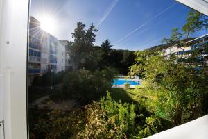a view of a swimming pool from a building at Jardins Fleuris Standing Presta in Mandelieu-la-Napoule
