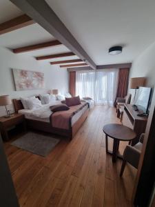 a bedroom with a bed and a desk and a television at Apartment B326 - Aparthotel Vučko in Jahorina