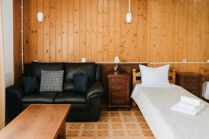 a living room with a couch and a bed at Lagos Central Suite DBV Guesthouse in Lagos