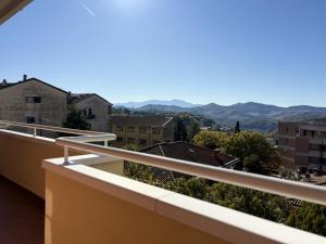 a balcony with a view of a city at Appartamento DIMORA GUIDI 3 camere 2 bagni URBINO in Urbino
