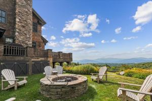 a patio with chairs and a fire pit in the yard at Panorama in Stowe