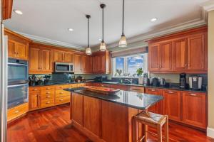 a kitchen with wooden cabinets and a large island at Panorama in Stowe