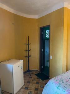 a room with a refrigerator in the corner of a room at Casa Maria Bonita in Aracati