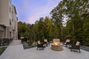 a patio with chairs and a fire pit in a yard at Residence Inn by Marriott Atlanta Peachtree City in Peachtree City