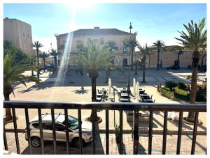 a balcony with a view of a parking lot with cars at Calipso Suite Room in Pozzallo