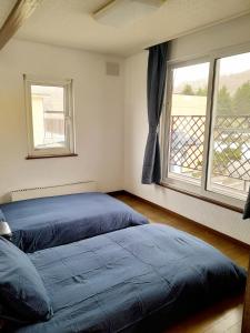 Postel nebo postele na pokoji v ubytování Merdeka House