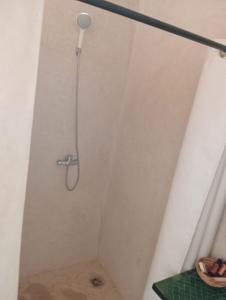 a shower with a shower head in a bathroom at LA HACIENDA Agafay Desert 