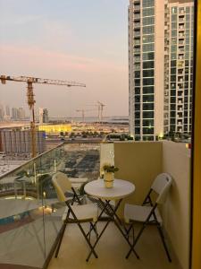 een balkon met een tafel en stoelen op een gebouw bij Deluxe studio water front in Dubai