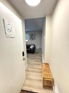 a hallway with a white door and a couch at Prince George Cozy Suite in Prince George +16 photos