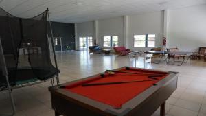 a room with a pool table in the middle of it at Cabañas La Sarita in La Consulta
