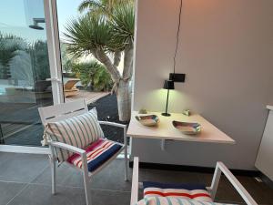 a dining room with a table and a chair at Villa Claus in Puerto Calero