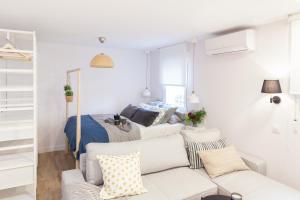 a living room with a couch and a bed at Charming Madrid lofts in Madrid
