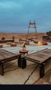 a group of picnic tables in the middle of a desert at Agafay dreams in Marrakech