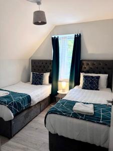 a bedroom with two beds and a window at Modern Flat Near Dover Castle in Dover