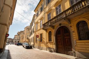a street with buildings and a car parked on the street at Piacenza centro in Piacenza