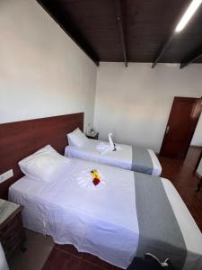 two beds in a hotel room with a flower on them at Piso de 2 habitaciones en Arrecife in Arrecife +9 photos