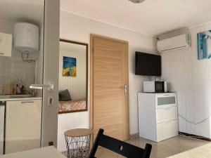 a small kitchen with a table and a microwave at Teona-Apartments in Sutomore